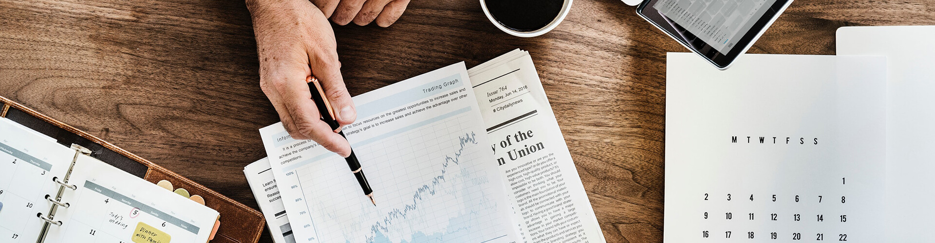 Hand pointing to financial graphs and documents, illustrating North TX Process Service's detailed legal records retrieval services in Dallas and Fort Worth.